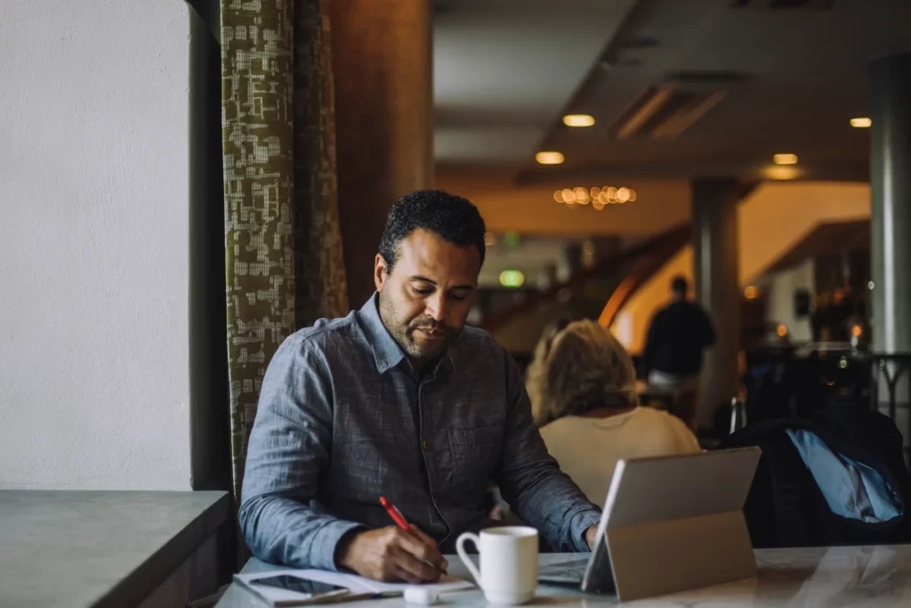 Man working at table in-cafe