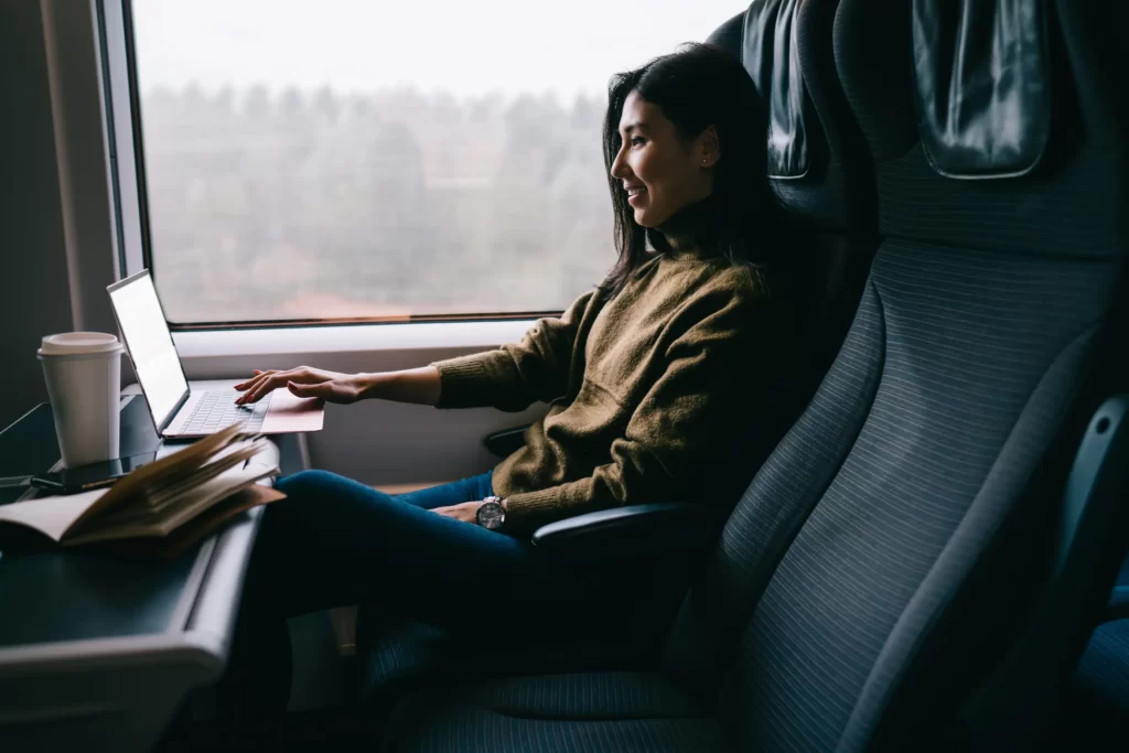 Woman working with laptop on train