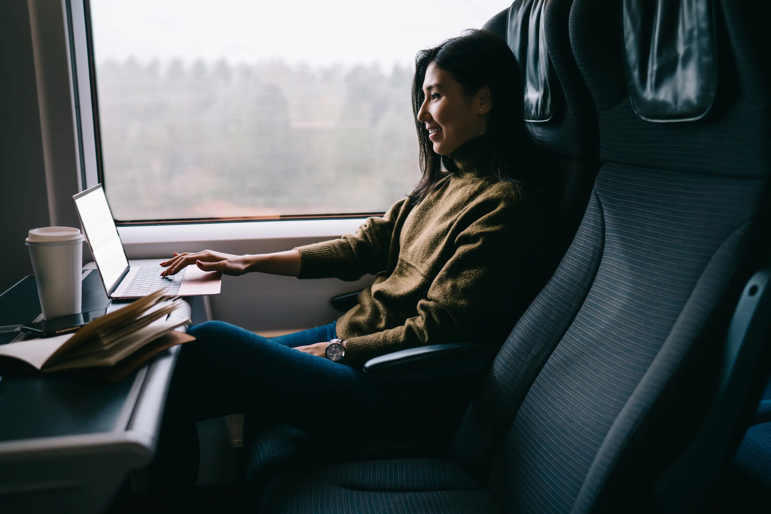 Woman working with laptop on train